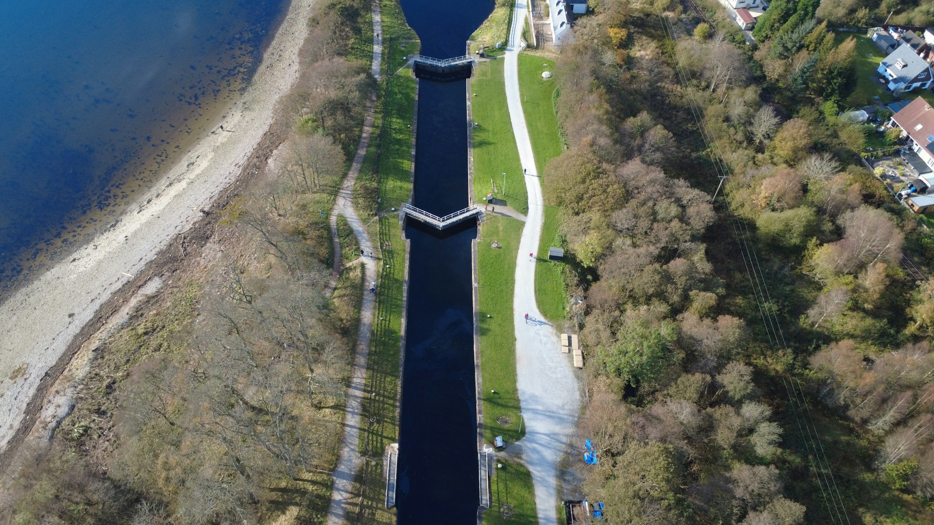Aerial view of a canal with trees and a path